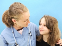Picture of a clinician with her arm around a pre-teen girl