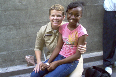 LTJG Stacey McBryde treats a patient at Moulton Hall Methodist School in Port of Spain, Trinidad.