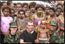 photo thumbnail: LCDR Aimee Treffiletti , Senior Airman Walker, LT Nazmul Hassan, and LCDR Stephen Piontkowski  at a welcoming ceremony at one of the schools where they collected water samples.