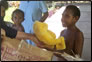 photo thumbnail: LCDR George Hanley passes out toys at Modilon Hospital in Madang, Papua New Guinea.