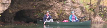 Canoes with rocky bluff in background