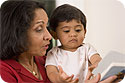 A grandmother reading to her grandson.