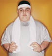 Overweight young man with a towel and wearing a sweatband