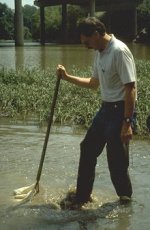 A man collects samples from water