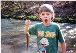 Picture of child - Nate - with his first fish. Photo by Wayne Davis EPA.