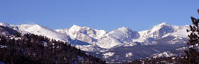 Photo view of the continental divide in Rocky Mountain National Park from the adjacent town of Estes Park, CO