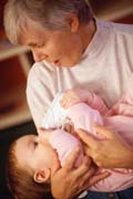 Grandmother Feeding Baby - (c) www.eyewire.com