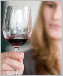 A photo of a woman holding a glass of wine.