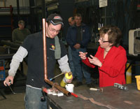 Secretary Gassman observes as Bryant Gardner demonstrates his skills. Bryant is apprentice plumber and son of President Fred Gardner and Vice President LuAnne Gardner. 