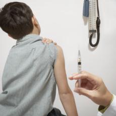 Photograph of a boy waiting for a shot from a healthcare professional
