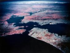 Ames Earth Resources project U-2 aircraft shot this oblique image off the coast of California, USA in 1972. The Golden Gate is in the foreground. As the image looks out across California the blue spot at the top enter is Lake Tahoe in the Sierra Nevada.