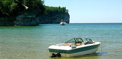 A visitor's boat is anchored just offshore from Chapel Beach.