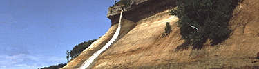 Bridalveil Falls cascades over the Pictured Rocks escarpment. This springtime waterfall slows to a trickle in the summer.