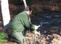 Park employee installs fascine along Sable Creek.