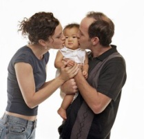 Two parents hold a child