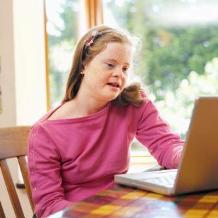 Special education child works on laptop