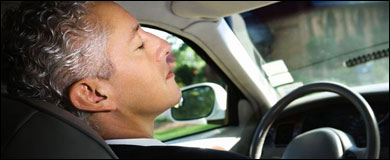 Male driver asleep at the wheel