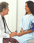 A female doctor talking to a female patient.