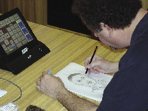 Photo of visual information specialist creating a composite drawing