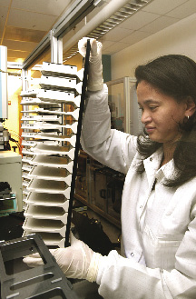 Photo of TEDAC analyst loading mass spectrometer