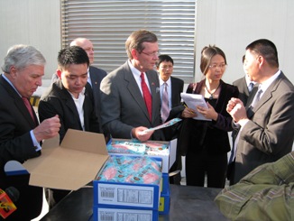 November 20, 2008 – U.S. Secretary of Health and Human Services (HHS) Michael O. Leavitt and the Honorable Andrew von Eschenbach, M.D., Commissioner of the HHS Food and Drug Administration, examine frozen tilapia ready for shipment to the United States, at the Luye Fisheries Aquatic Farms, outside of Guangzhou, Guangdong Province, in the People's Republic of China. Secretary Leavitt and Commissioner von Eschenbach were in China to open the first offices of the HHS Food and Drug Administration (FDA) outside of the United States; HHS/FDA is now working out of three locations in China, the U.S. Embassy in Beijing and the U.S. Consulates General in Guangzhou and Shanghai. (Photo Credit: Bill Steiger, HHS)
