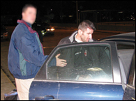 A Detroit FBI agent puts Albanian criminal Drini Brahimllari into a car after his February 2008 return to the U.S. to face racketeering charges in Michigan.
