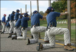 Photo of agents at the firing line shooting from one knee