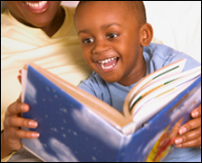 Child and mother reading a book.