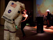 Woman dancing with astronaut mascot