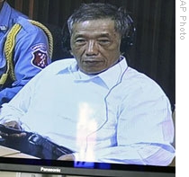 Former Khmer Rouge prison chief Kaing Guek Eav, also known as Duch, is seen on a screen at a court press center, 20 Apr 2009