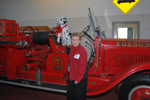 Photo of Motherlode District volunteer admiring the 1937 Folsom Fire Department Engine Number 1