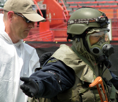 An FBI SWAT team member is checked for possible radiological contamination