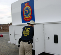 Evidence response expert gathering equipment from a truck