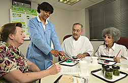 Food technologist works with panelists to evaluate reference samples of flavor in fresh-cut cantaloupe: Click here for full photo caption. 