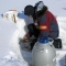 Man and equipment in snow (PolarHusky.com)