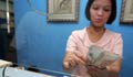 Woman behind the counter counting money