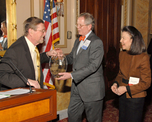 Senator Pete V. Domenici (left) receives his award from LSC Board Chairman Frank B. Strickland and LSC President Helaine M. Barnett.