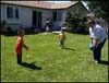 [Photo: Terri playing catch with grandkids]