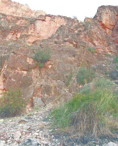 Photograph of yellow rop depicts the path that Sprangler's third wife fell (160 feet) after he pushed her from an inner wall of the Grand Canyon