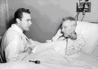 Dr. Wolf at bedside with patient