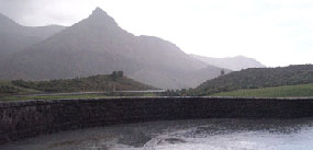 Image of sheep rock taken from the patio of the paleontology center during a rain storm.