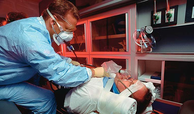 Photograph of medical personnel tending to an injured man