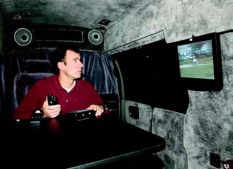 Photograph of a man conducting surveliance from inside a vehicle