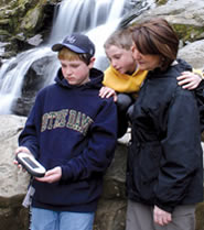 Visitors at Dark Hollow Falls looking at a GPS Ranger unit.