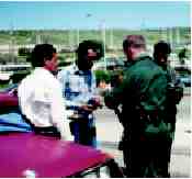 Photograph of police officers talking to some hispanic men