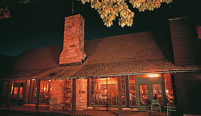 Looking in the windows of Rustic Big Meadows Lodge at night.