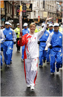 The Olympic torch is carried along the streets of London