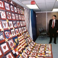 Secretary Mineta admires a quilt presented by DOT to the Department of Defense bearing the name of every woman who died at the Pentagon and on Flight 77 on September 11th. If you are a user with a disability and cannot view this image, please call 800-853-1351 or email answers@bts.gov for further assistance.