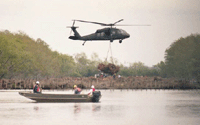 helicopter dropping Christmas trees into water