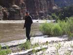 photo of Marcus Peacock standing on the bank of a river